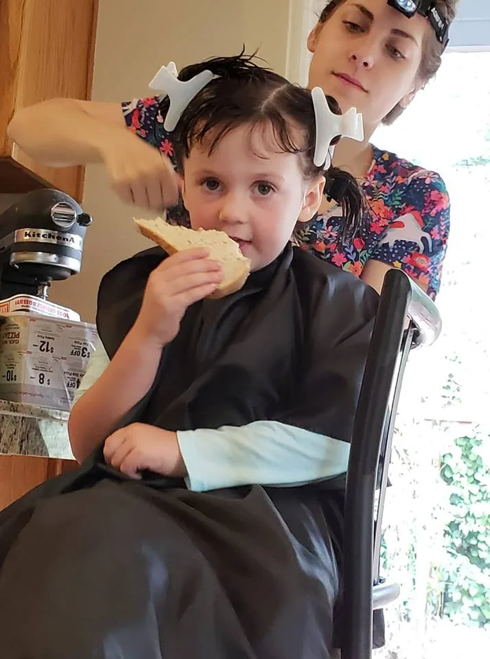 lice treatment and lice removal on a young girl in home lice treatment and lice removal on a young girl in home