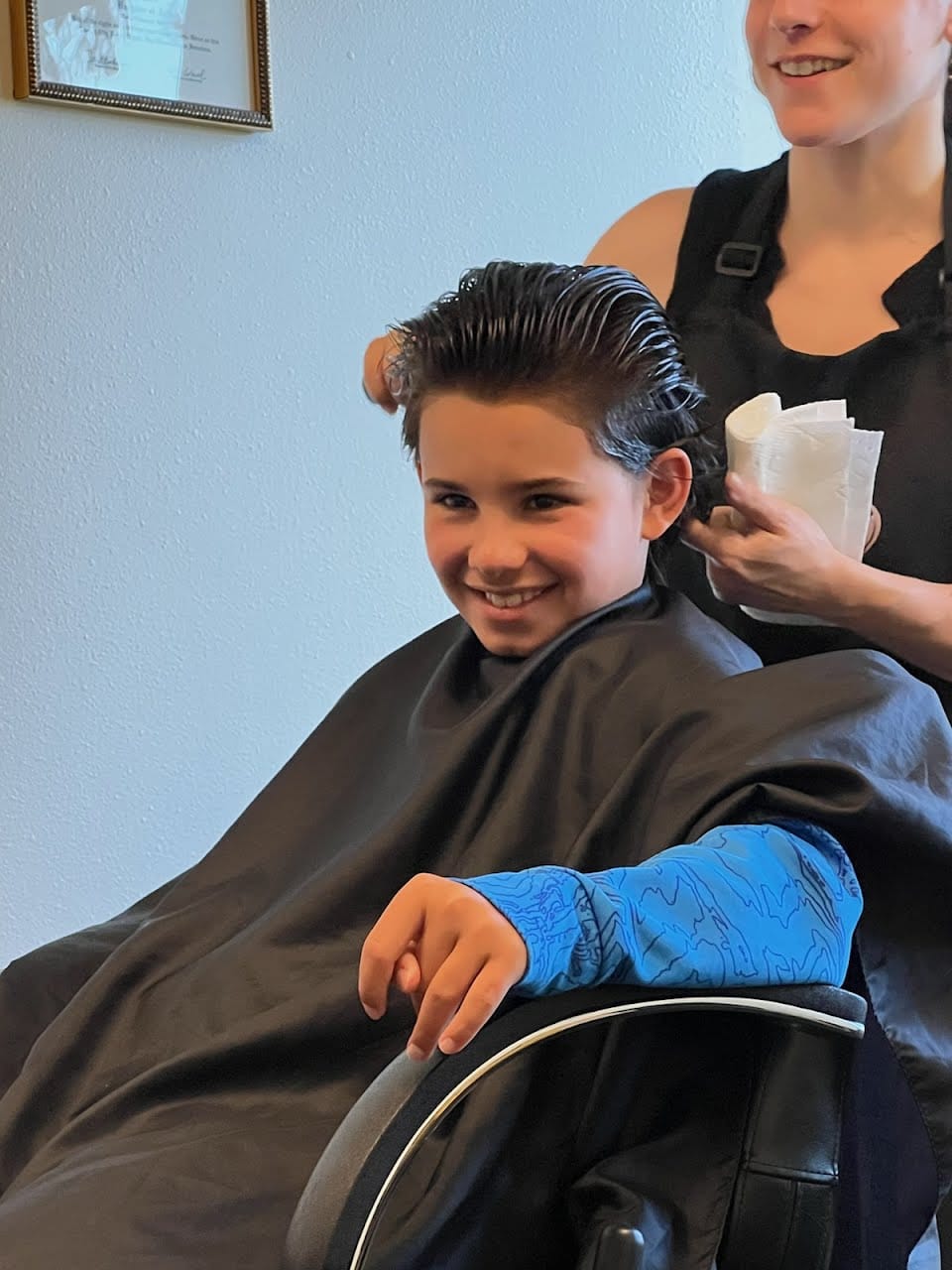 Child sitting for lice treatment at a lice clinic
