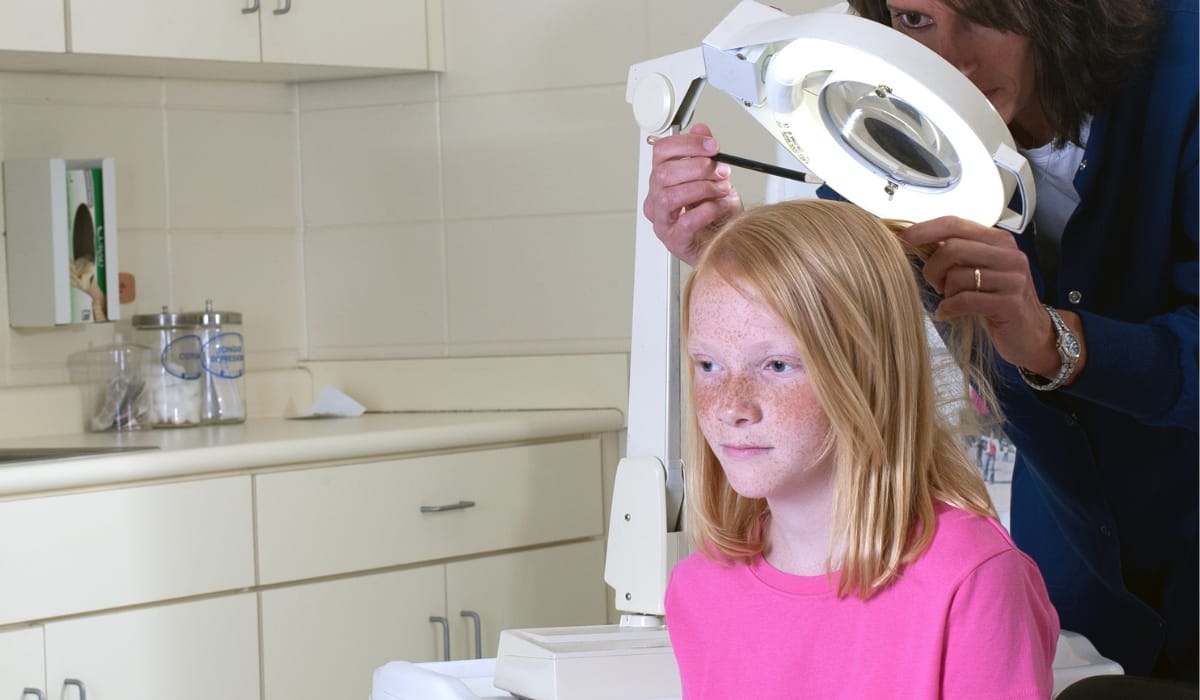 Lice treatment specialist examines child in Seattle clinic